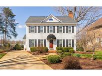 Charming two-story home featuring a symmetrical facade, black shutters, and manicured landscaping at 3523 Elk St, Burlington, NC 27215