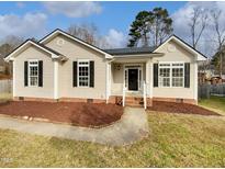 Charming single-story home featuring a well-manicured lawn and inviting entrance at 4023 Cashew Dr, Raleigh, NC 27616