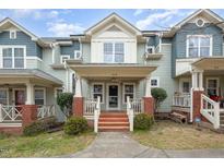Inviting townhome exterior with charming front porch, brick accents, and well-maintained landscaping at 521 Eastway Ave # Apt B, Durham, NC 27703
