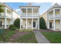 Charming two-story home with a covered front porch and well-manicured landscaping at 7732 Acc Blvd, Raleigh, NC 27617