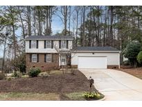 Charming two-story home featuring a brick facade, vinyl siding, and a spacious two-car garage at 1036 Whetstone Ct, Raleigh, NC 27615