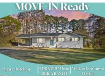 Charming single-story home with well-manicured lawn, carport, and mature trees at 109 Hardee St, Clayton, NC 27520