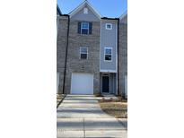 Charming townhome exterior features a one car garage and a gray brick and siding facade at 1913 Fishamble St, Fuquay Varina, NC 27526