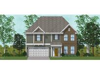Charming two-story home featuring mixed siding and brick exterior with a two-car garage and a welcoming front porch at 2102 Channel St, Graham, NC 27253