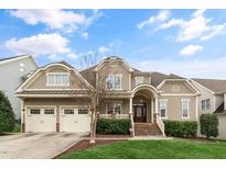 Charming home featuring a manicured lawn and inviting two-car garage at 306 Village Orchard Rd, Cary, NC 27519