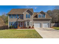 Charming two-story home with blue shutters and a well-manicured lawn showcasing curb appeal at 424 Crystal Spring Dr, Sanford, NC 27332