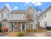 Charming two-story townhome with well-maintained landscaping and a welcoming front porch at 5321 Cog Hill Ct, Raleigh, NC 27604
