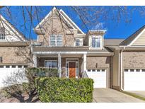Charming townhome features a brick facade, covered porch, and attached one car garage at 625 Canvas Dr, Wake Forest, NC 27587