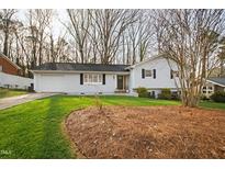 Charming home with a well-maintained lawn and attached garage at 6713 Brookhollow Dr, Raleigh, NC 27615