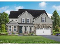 Charming two-story home featuring stone accents, a welcoming front porch, and a well-manicured lawn at 72 Cultivator Ct, Angier, NC 27501