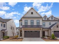 Beautiful two-story townhome with a brick garage, situated on a quiet street under a partly cloudy sky at 94 Paperwhite Pl, Clayton, NC 27527