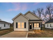 Charming, newly built one-story home featuring a covered porch and freshly poured concrete driveway at 1021 E Edgerton St, Dunn, NC 28334