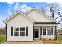 Charming single-story home featuring white siding, black shutters, and a welcoming front porch at 1021 E Edgerton St, Dunn, NC 28334