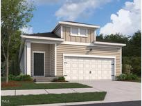 Charming home featuring a two-car garage and neutral siding, set against a backdrop of lush greenery and blue skies at 1145 Solace Way, Rolesville, NC 27571