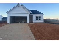 New construction home featuring a two-car garage, white siding, and a well-manicured lawn in a serene neighborhood at 11844 Ayshire Dr, Middlesex, NC 27557