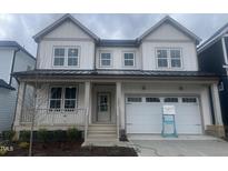Charming two-story home featuring a welcoming front porch and a two-car garage at 1221 Porters Call Dr, Wendell, NC 27591