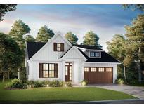 Charming white farmhouse with black roof, lush lawn, and a stained wood garage door at 13301 Nc 27 Hwy # 3, Broadway, NC 27505