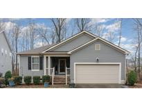 Charming single-Gathering home featuring a welcoming front porch and attached two-car garage at 1600 Frog Hollow Way, Wake Forest, NC 27587