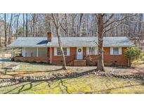 Charming brick ranch home with a well-maintained front yard and inviting entrance at 1614 Clearwater Lake Rd, Chapel Hill, NC 27517