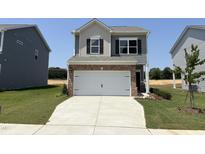 Charming two-story home featuring a two-car garage and well-manicured lawn at 192 Bruce Dr, Dunn, NC 28334