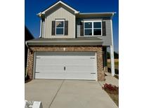 Two story home featuring an attached two car garage and brick and vinyl siding at 192 Bruce Dr, Dunn, NC 28334