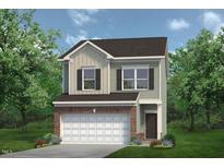 Charming two-story home with a brick-accented garage and well-maintained lawn, nestled among mature trees at 192 Bruce Dr, Dunn, NC 28334