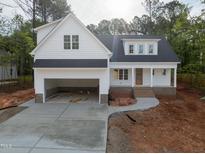Charming two-story home with a large driveway and an attached two-car garage at 215 Purslane Dr, Franklinton, NC 27525
