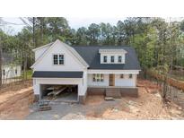 Charming two-story home with a two-car garage, a welcoming front porch, and a beautifully landscaped yard at 215 Purslane Dr, Franklinton, NC 27525