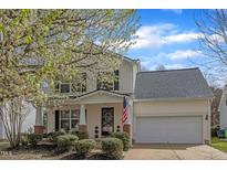Charming two-story home with light siding, attached garage, landscaped yard, and welcoming front porch at 3608 Croydon Mill Way, Raleigh, NC 27616