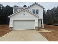 Charming two-story home featuring a two-car garage and concrete driveway at 6814 Galloway Dr, Middlesex, NC 27557