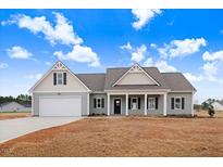 Charming single-story home with a well-manicured lawn and a welcoming front porch at 9246 Otter Ct, Middlesex, NC 27557