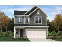 Charming two-story home with gray siding, a two-car garage, and manicured landscaping at 10068 Regal Dr, Angier, NC 27501