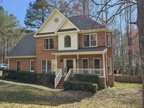 Charming two-story brick home with a welcoming front porch and landscaped yard at 1025 Shellrock Dr Dr, Wake Forest, NC 27587