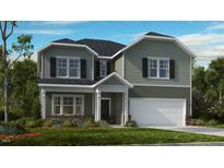 Charming two-story home features a clean color palette, attached garage, and manicured lawn at 1133 Sun Springs Rd, Wake Forest, NC 27587