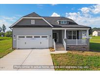 Charming home with a two-car garage, gray siding, and a cozy front porch at 1794 Parham Dr, Graham, NC 27253