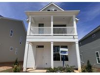 Charming new construction home with a white exterior, a covered porch, and upper level balcony at 316 White Oak Garden Way # 217, Garner, NC 27529