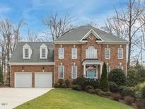 Charming brick home featuring a manicured lawn and an attached two-car garage at 3359 Hampton Rd, Raleigh, NC 27607