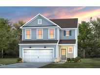 Charming two-story home with gray siding, white trim, a two-car garage, and a manicured lawn at 521 Providence Springs Ln, Fuquay Varina, NC 27526