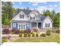 Beautiful two-story home featuring manicured landscaping and a charming front porch for relaxing in the outdoors at 6102 Cabin Branch Dr, Durham, NC 27712