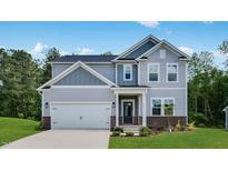 Charming two-story home with a two-car garage, well manicured lawn and a beautifully designed facade at 631 Contento Ct, Sanford, NC 27330