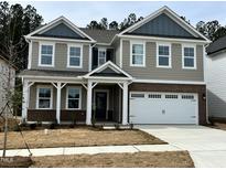Beautiful two-story home with a two-car garage and covered entryway at 660 Sun Meadow Dr, Wake Forest, NC 27587