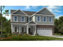 Charming two-story home with brick accents, a covered porch, and a two-car garage at 660 Sun Meadow Dr, Wake Forest, NC 27587