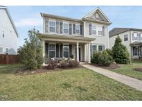 Charming two-story home with a welcoming front porch and beautifully landscaped front yard at 714 Chapanoke Rd, Raleigh, NC 27603