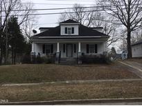 Charming home featuring a covered front porch and inviting curb appeal, perfect for relaxing outdoors at 925 Harris St, Burlington, NC 27217