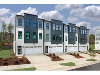 Modern townhome exteriors showcasing three-story facade and individual garages at 10624 Pleasant Branch Dr # 7, Raleigh, NC 27614