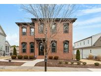 Stunning two-story brick home with black window trim and a well-manicured front yard, offering classic elegance and curb appeal at 1354 Briar Chapel Pkwy, Chapel Hill, NC 27516
