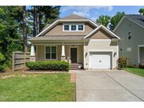 Charming home showcasing a well-manicured front lawn and inviting exterior with a private driveway and attached garage at 151 Pineland Cir, Raleigh, NC 27606