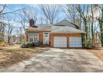 Charming brick home with a two-car garage and inviting front entrance at 201 N Knightsbridge Rd, Cary, NC 27513