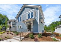 Charming two-story blue home with landscaped front yard and inviting entrance in a desirable neighborhood at 2218 Woodrow St, Durham, NC 27705