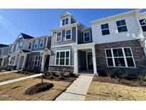 Charming townhome with stone accents, well-manicured lawn, and welcoming entrance at 2353 Whitewing Ln, Wendell, NC 27591